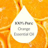 Orange essential oil bottle with slices of fresh orange for uplifting aromatherapy.